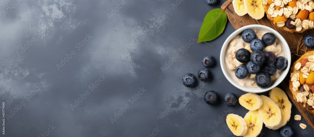 Top view of plant based dessert vegan oatmeal banana and blueberry muffins on a gray background