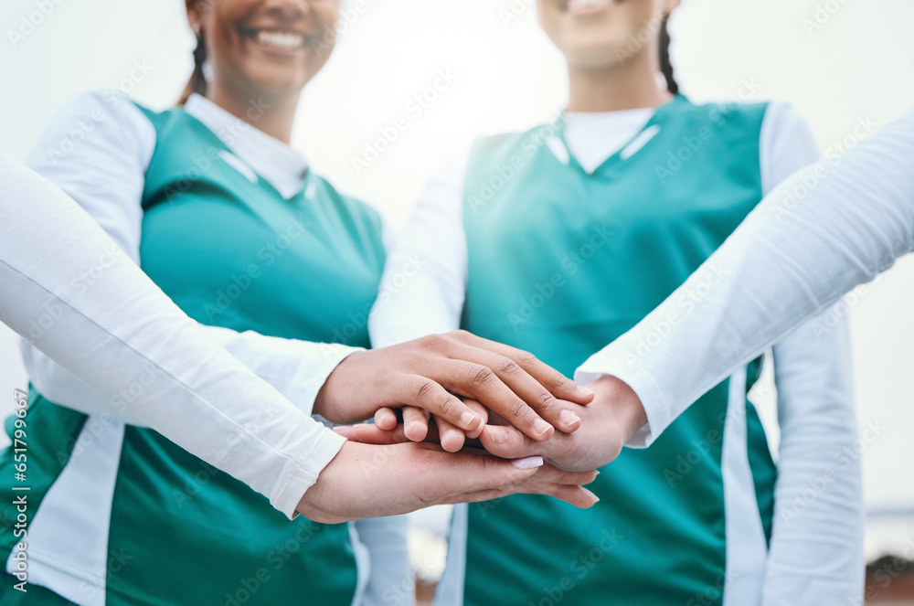 Hands, sports women or team in huddle with support, smile or plan for a hockey training game. Low angle, stack or happy female athletes in practice for exercise or match together with pride or unity