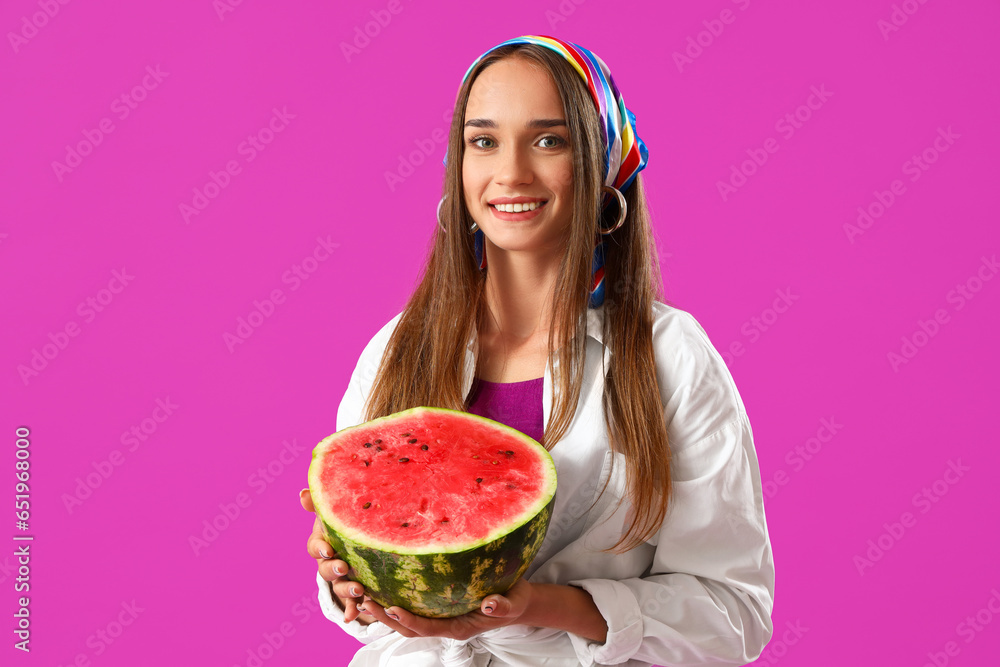 Young woman with fresh watermelon on purple background