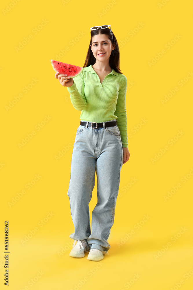 Young woman with fresh watermelon on yellow background