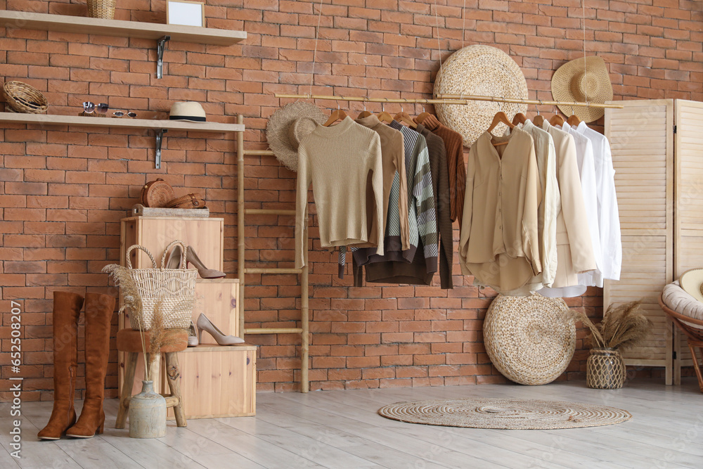 Interior of modern boutique with stylish female clothes and accessories