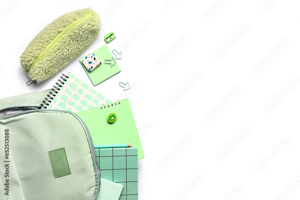 Stylish school backpack with pencil case and different stationery supplies on white background