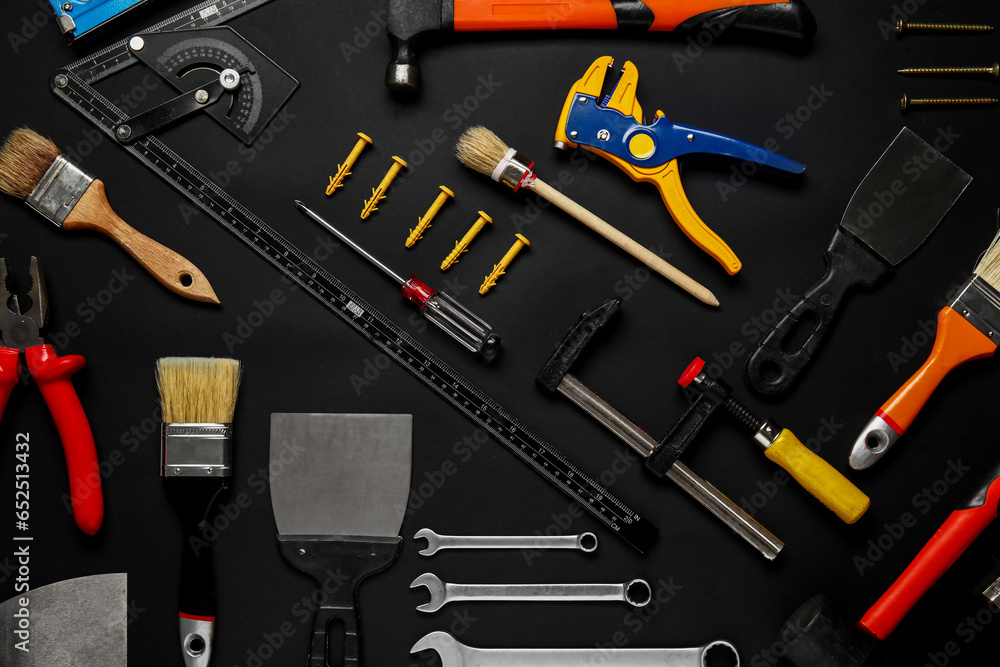 Set of construction tools on black background