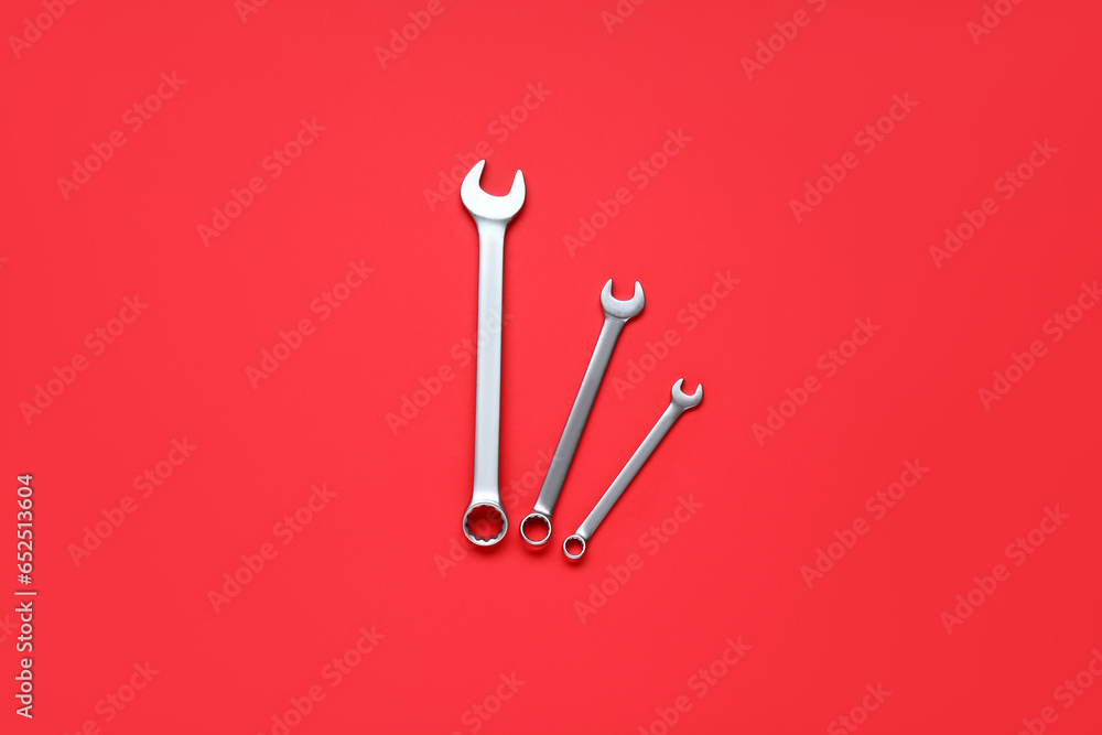 Different spanners on a red background