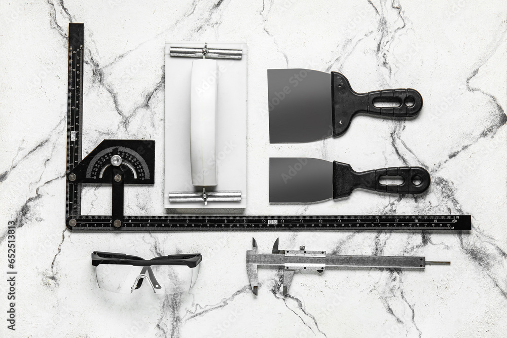 Set of construction tools on white marble background