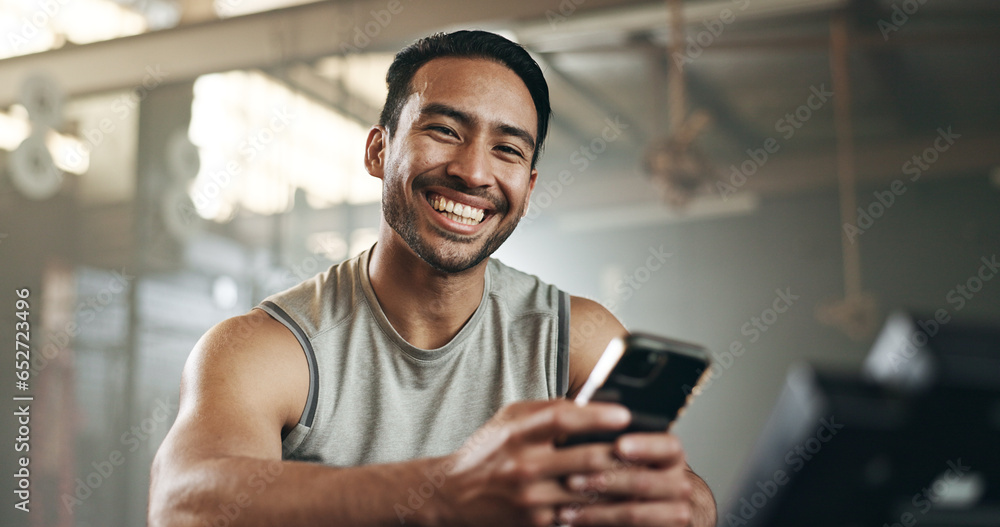 Happy asian man, phone and fitness in social media, communication or networking at gym. Portrait of active male person smile for online texting or chatting on mobile smartphone at indoor health club