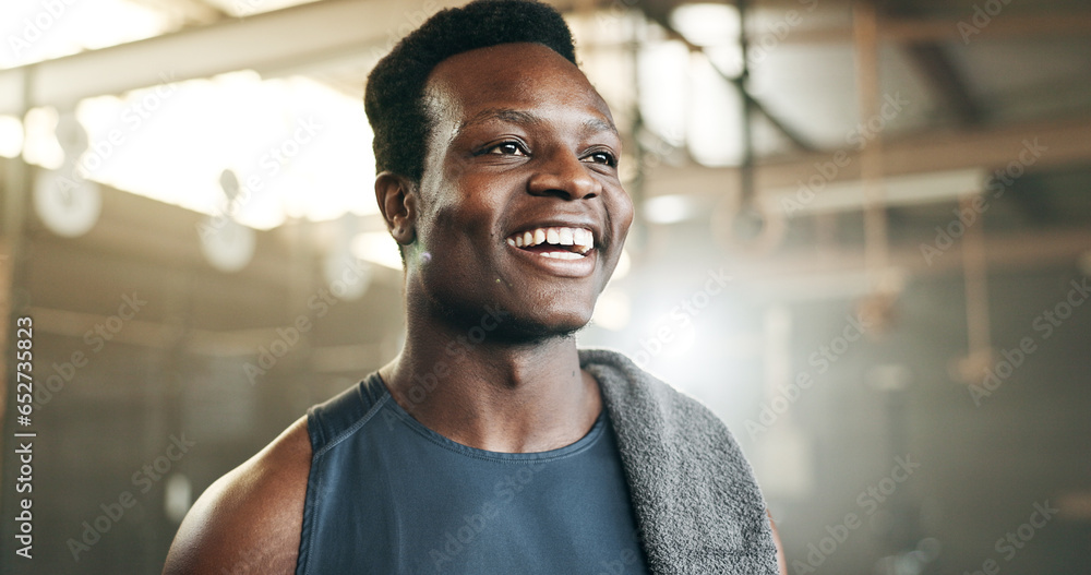 Smile, fitness and face of black man at a gym for training, exercise and athletics routine. Happy, mindset and African male personal trainer at sports studio for workout, progress and body challenge