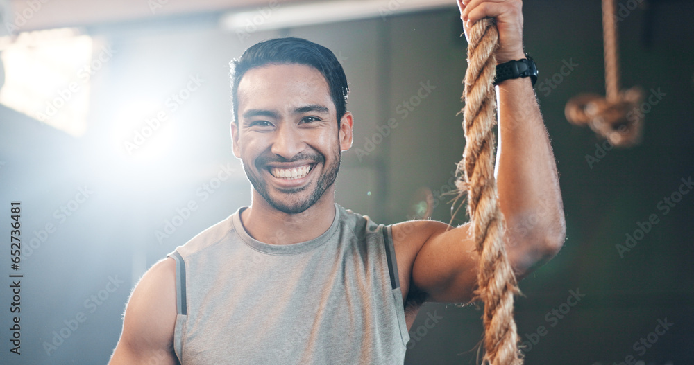 Fitness, gym and face of man with rope for training, bodybuilder exercise and intense workout. Sport, personal trainer and portrait of happy person with equipment for wellness, performance and muscle