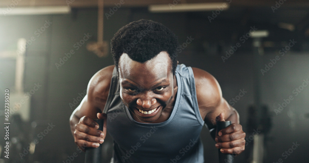 Black man at gym, weight sled and muscle endurance, strong body and core balance power in fitness. Commitment, motivation and bodybuilder in workout challenge for health and wellness on push machine.