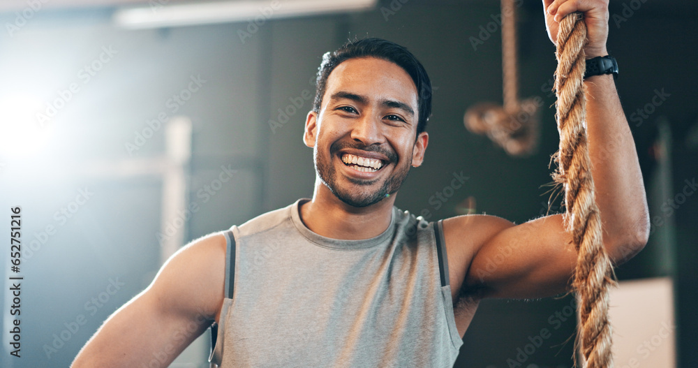 Fitness, gym and face of man with rope for training, bodybuilder exercise and intense workout. Sport, personal trainer and portrait of happy person with equipment for wellness, performance and muscle