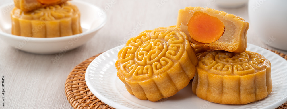 Delicious Cantonese moon cake for Mid-Autumn Festival food mooncake on wooden table background.