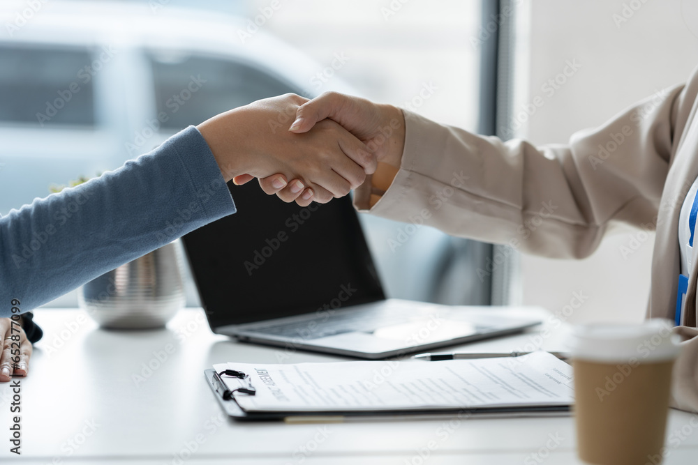 Businesswoman, office worker shaking hands, investing and expressing joy of cooperation. Successful business in real estate discussing contract documents financial and tax system concepts.