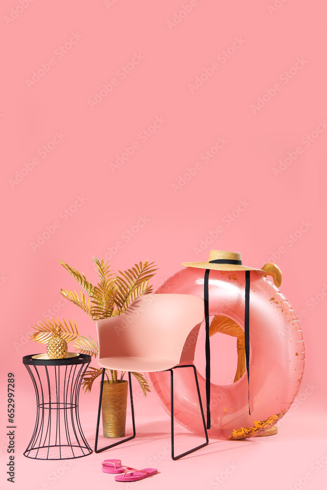 Composition with chair, different decorations and beach accessories on pink background. Travel concept