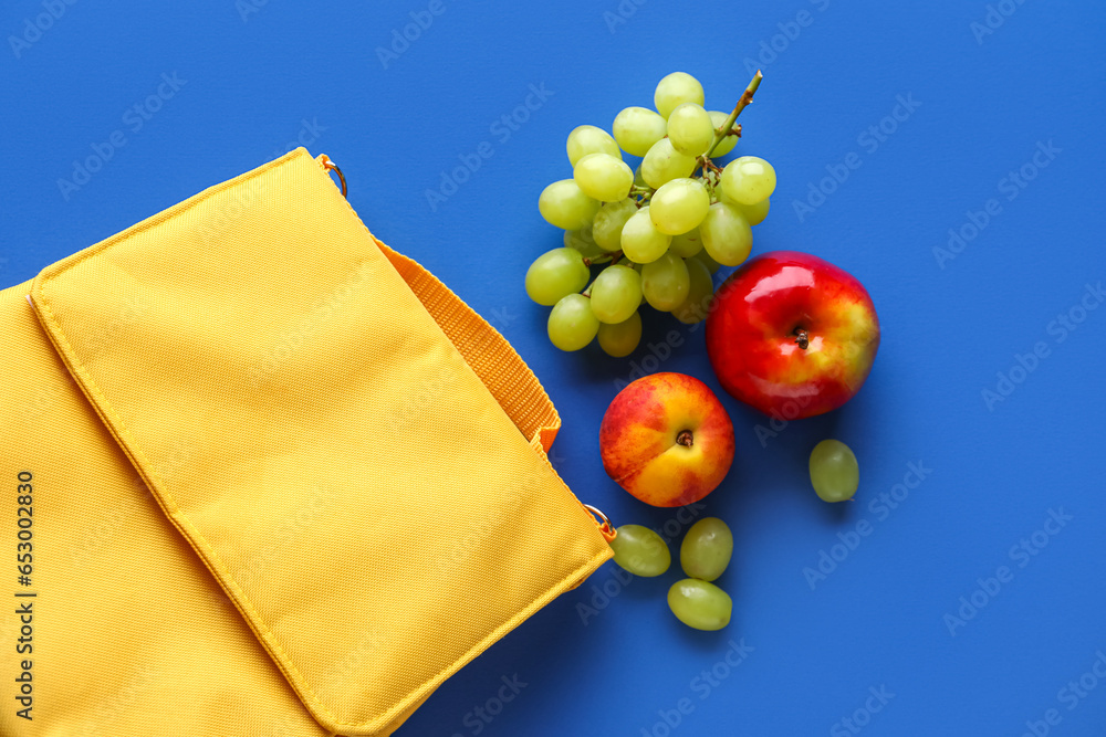 Lunch box bag with different fruits on blue background