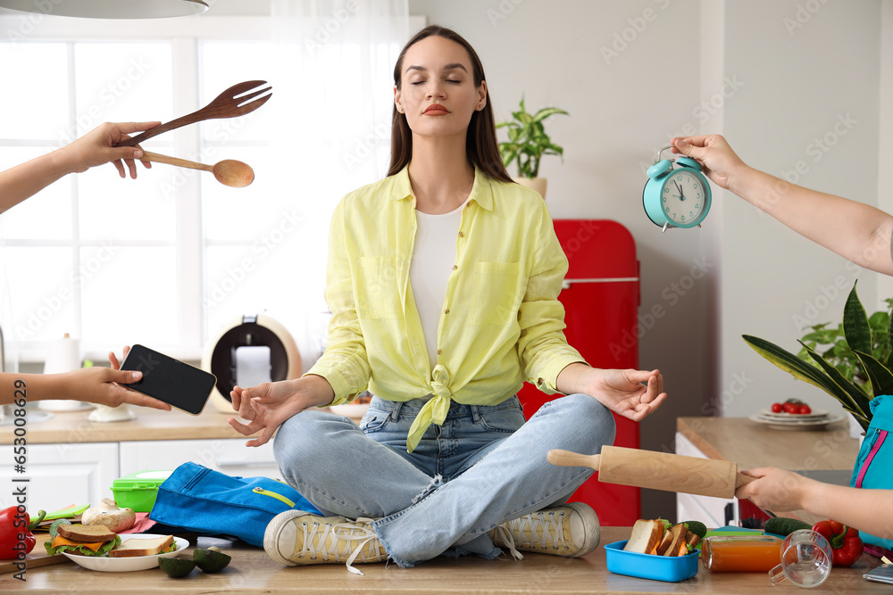 Young woman with a lot of things to do meditating in kitchen