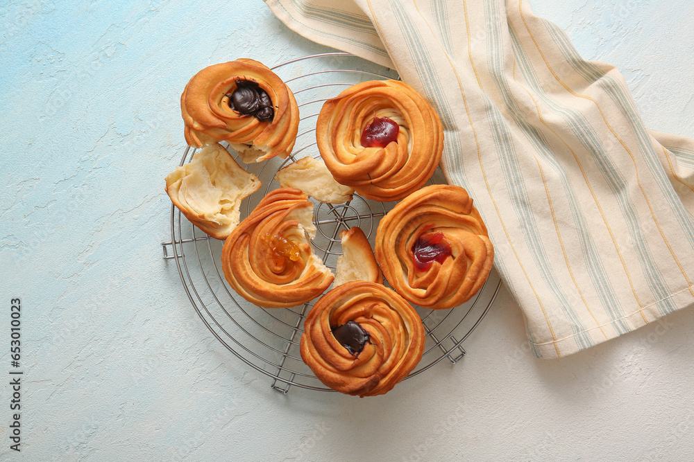 Grid of tasty cruffins with chocolate and jam on white background