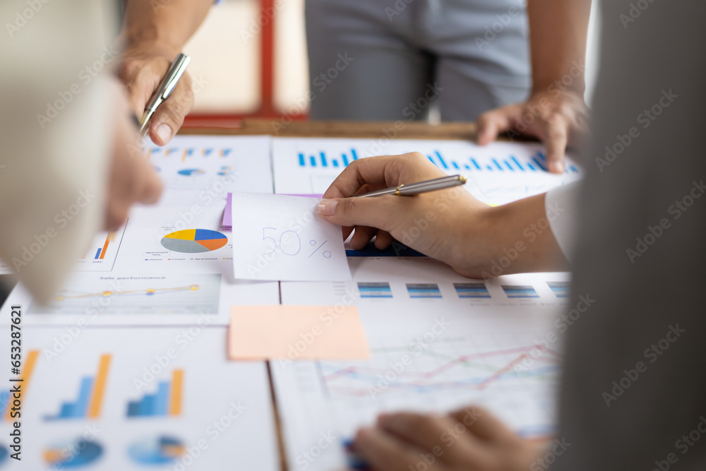 Business people discuss marketing growth chart and make business plan. Business meeting, financial consultants brainstorm analysis of statistical charts in financial reporting documents.