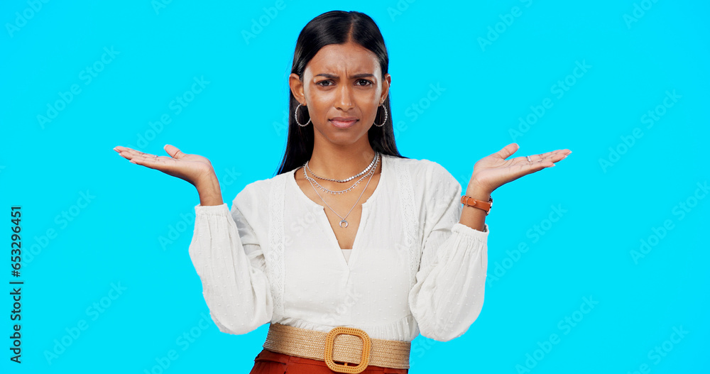 Comparison, thinking and what hands of woman portrait with choice in a studio with question or idea emoji gesture. Decision, doubt and female person with option, balance or shrug and blue background