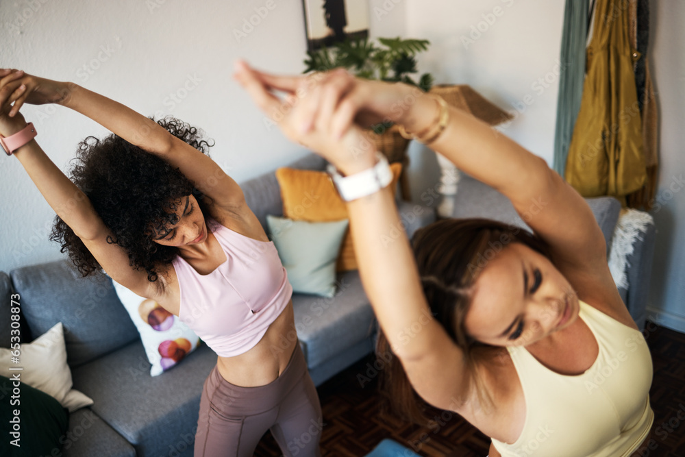 Yoga, stretching and girl friends in the living room doing a warm up exercise together for wellness. Calm, peace and young women doing pilates workout for breathing in the lounge at modern apartment.