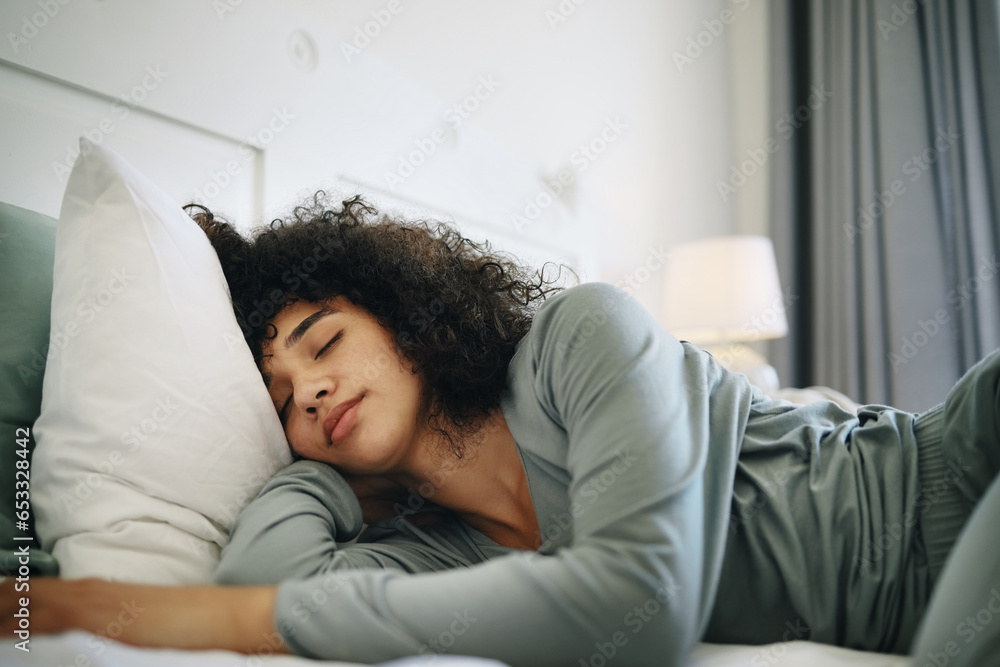 Woman, Tired and sleeping on bed in bedroom with fatigue and burnout, dream and relax for stress relief. Exhausted, person and girl in house or home lying on pillow in apartment for wellness and calm