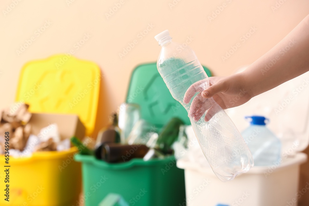 Woman throwing garbage into trash bin, closeup. Recycling concept