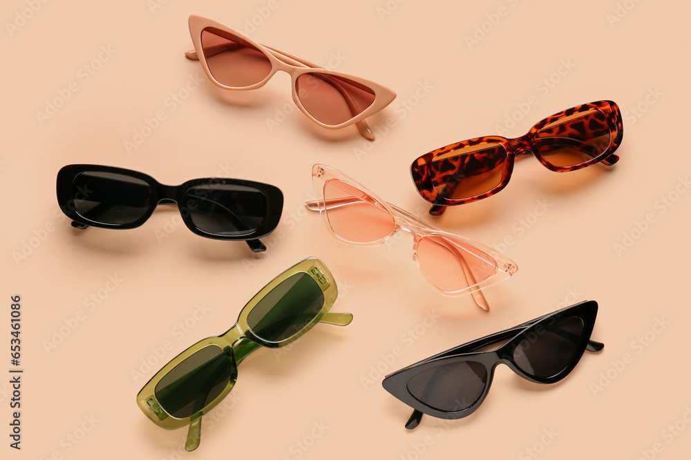 Stylish sunglasses on beige background