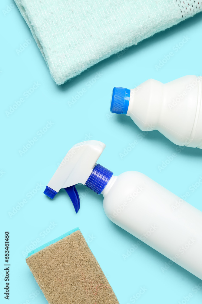 Different cleaning supplies on blue background