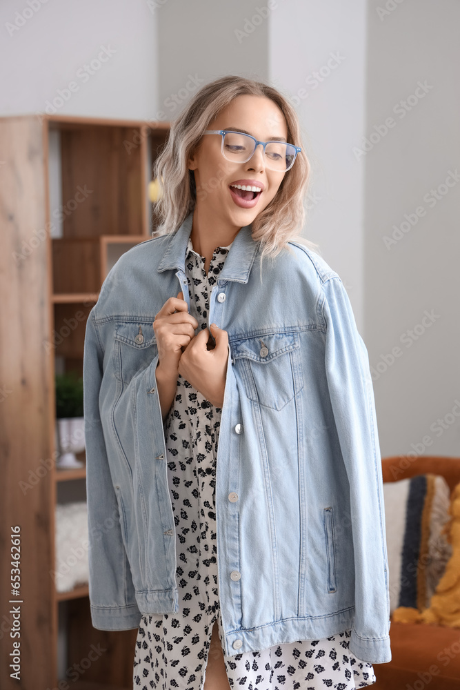 Happy young woman in stylish eyeglasses at home