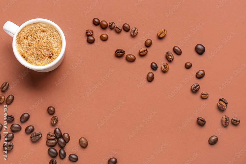 Frame made of coffee beans and cup with hot espresso on brown background