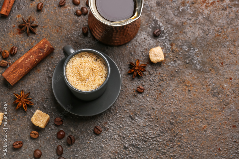 Cup and jezve of hot espresso on dark background