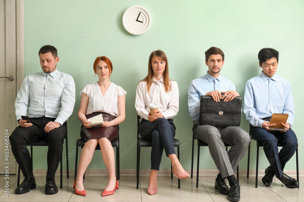 Young applicants waiting for job interview in room