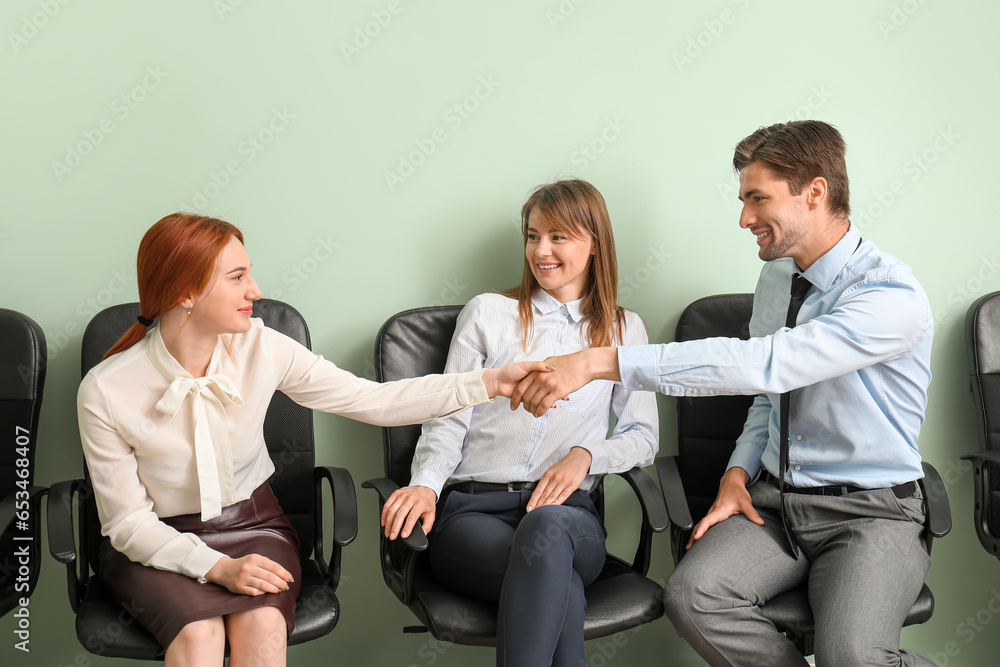 Young applicants waiting for job interview in room