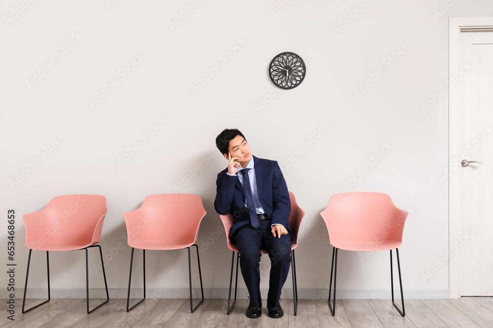 Asian applicant waiting for job interview in room