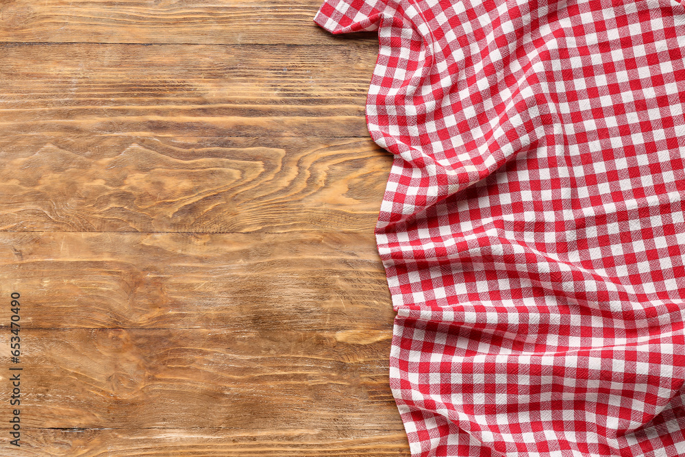 Red checkered napkin on wooden background