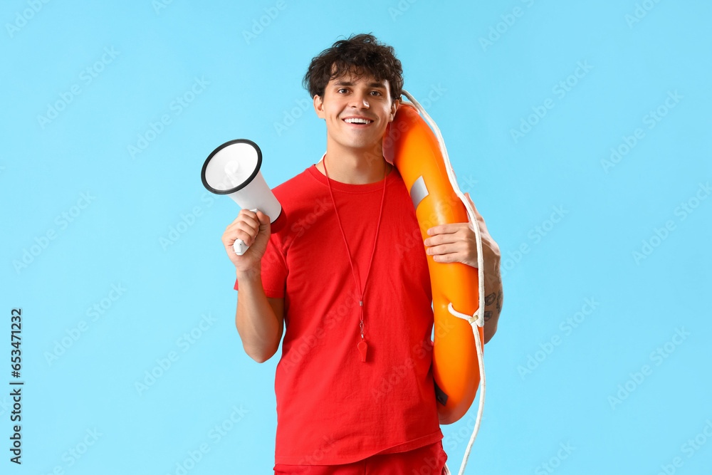 Male lifeguard with ring buoy and megaphone on blue background