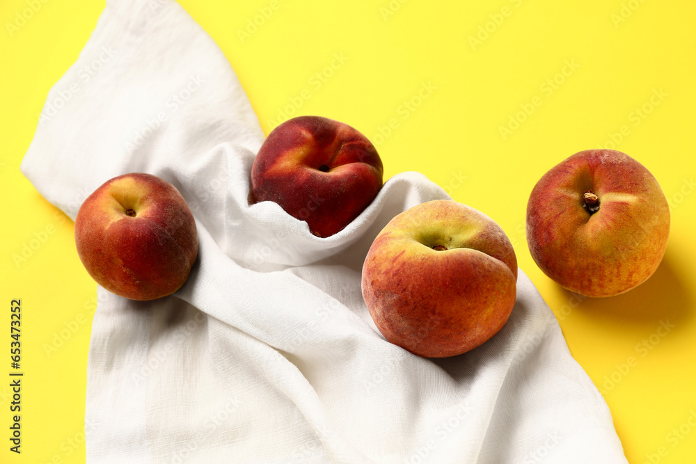 Sweet peaches on yellow background