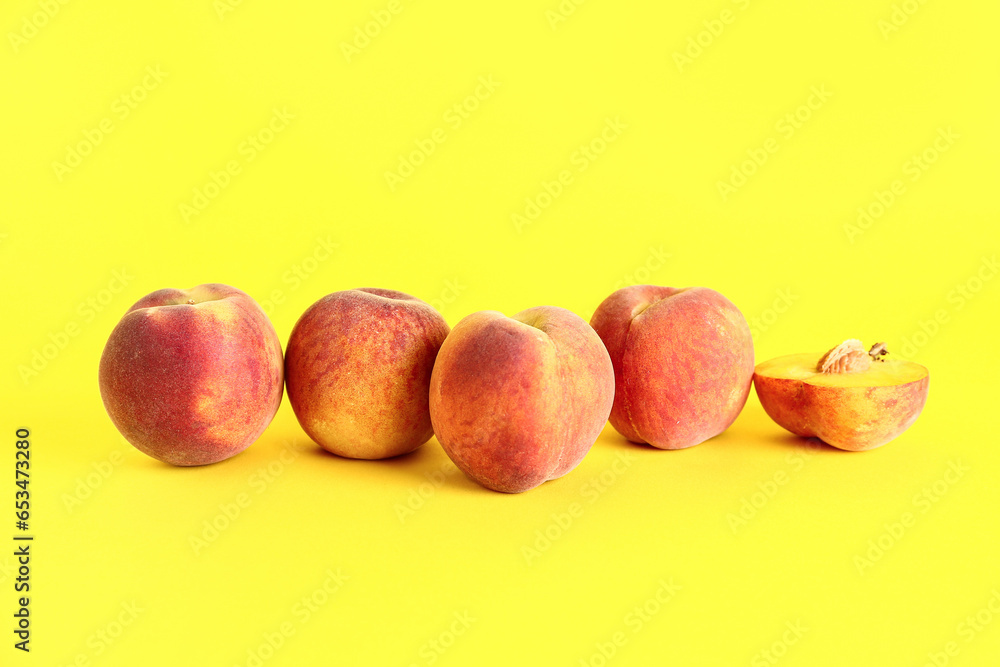 Sweet peaches on yellow background