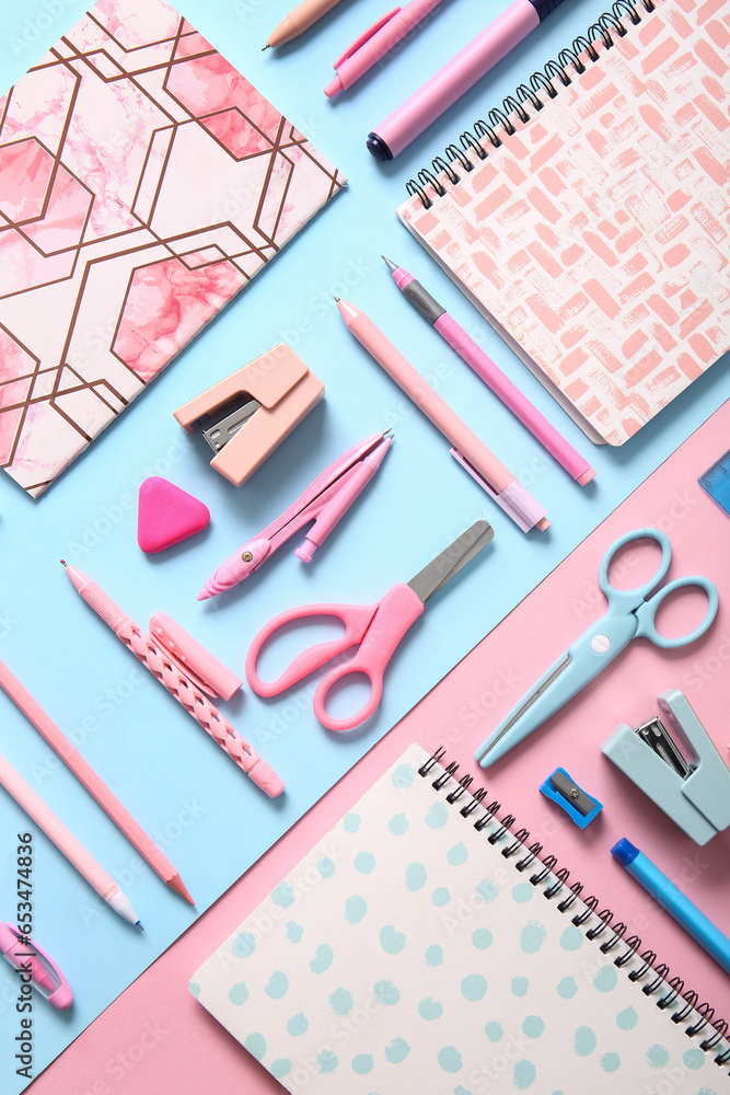 Different school stationery and notebooks on colorful background