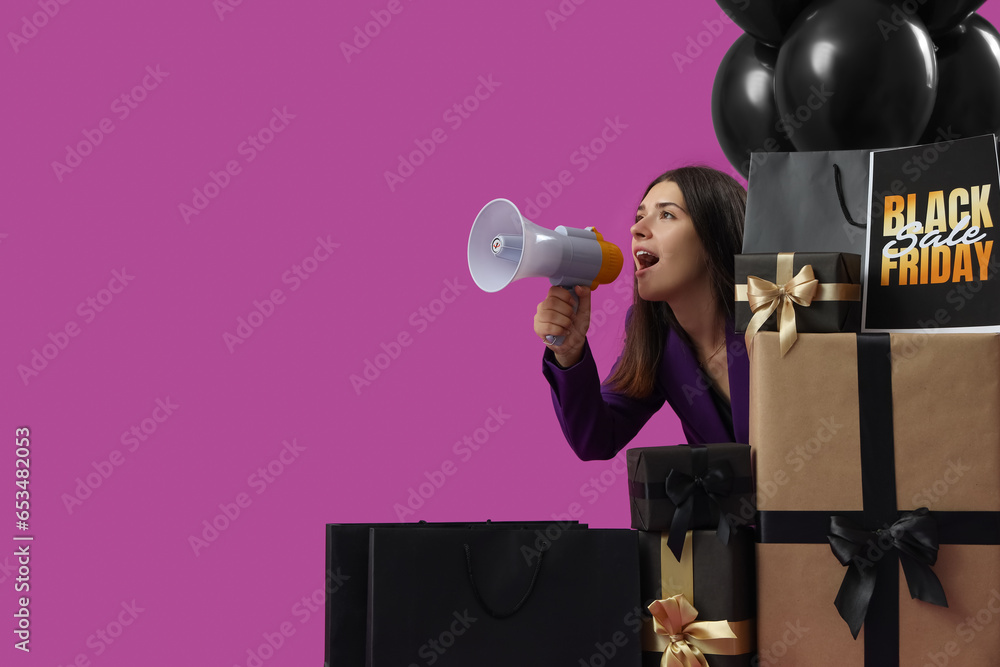 Young woman with shopping bags, gifts and balloons shouting into megaphone on purple background. Black Friday sale