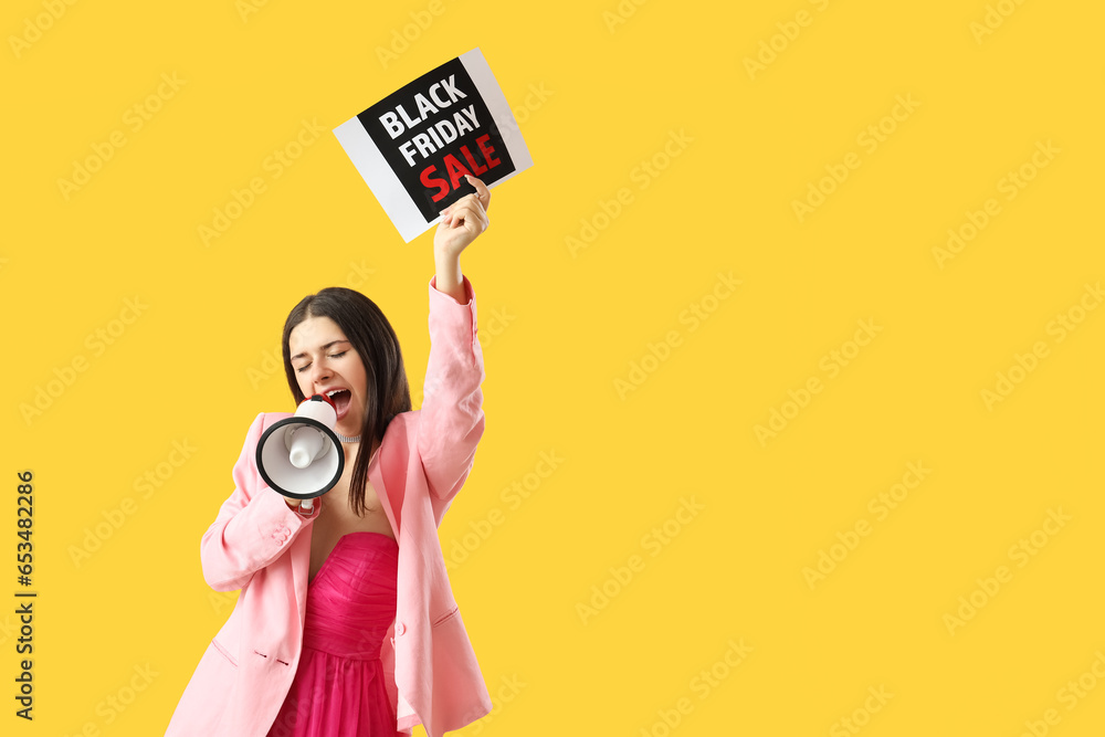 Young woman shouting into megaphone on yellow background. Black Friday sale