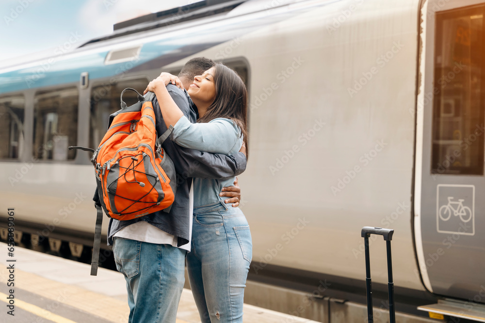 a young beautiful couple embraces on the platform meeting, saying goodbye  the spouse, friend. Travel  lifestyle concept