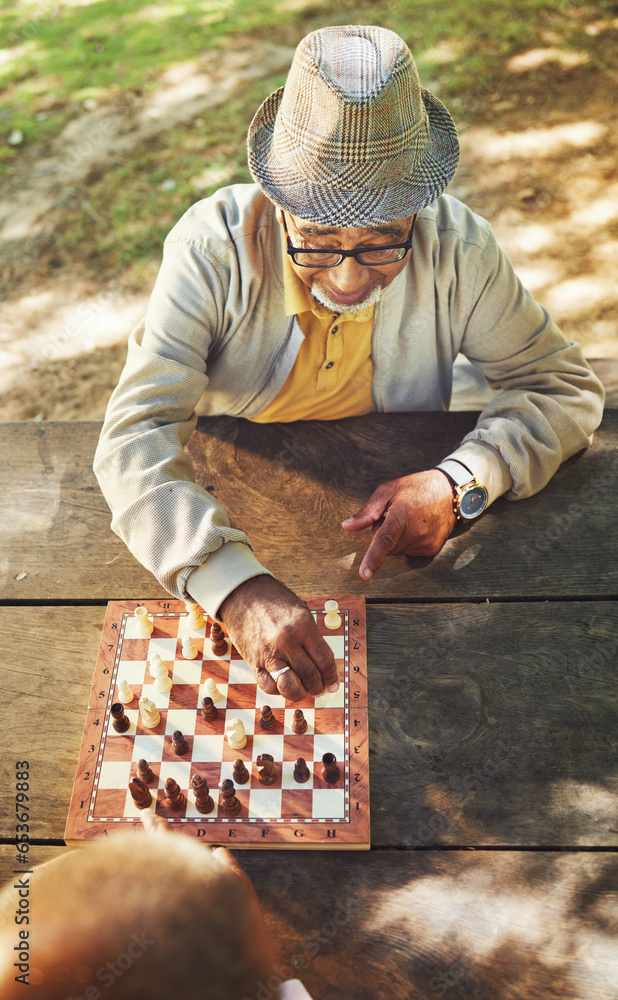 Senior men, chess and game in park, above and moving with strategy, problem solving or competition. Elderly friends, retirement and playing together for contest with king, queen and knight in summer