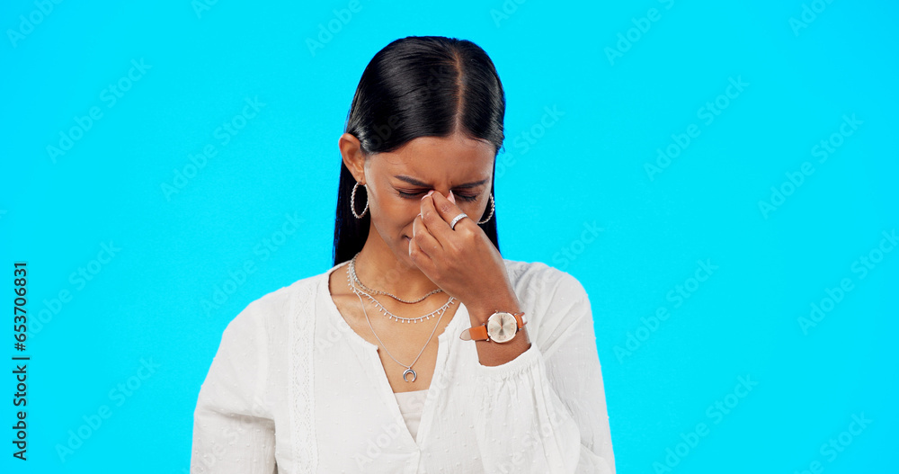 Business woman, headache and eye pain with migraine, allergy and stress in studio. Female professional, health problem and tired from anxiety with mistake, fatigue and work fail in blue background