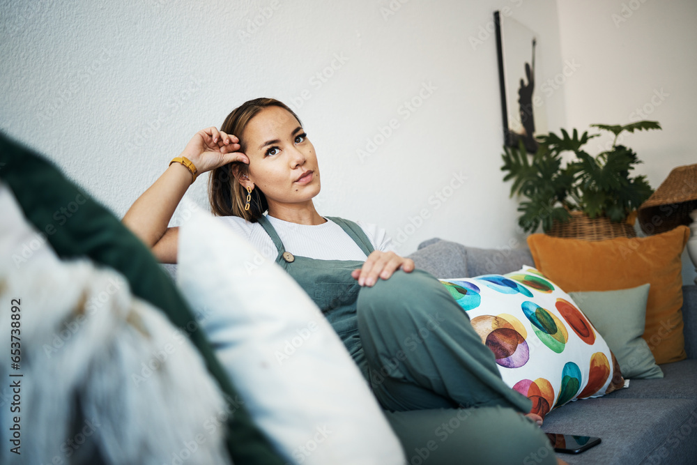 Woman, face and thinking on sofa of home for peace, relaxing in living room apartment or house. Person, calm and wellness for self care and zen with ideas, thoughts and inspiration in lounge on couch