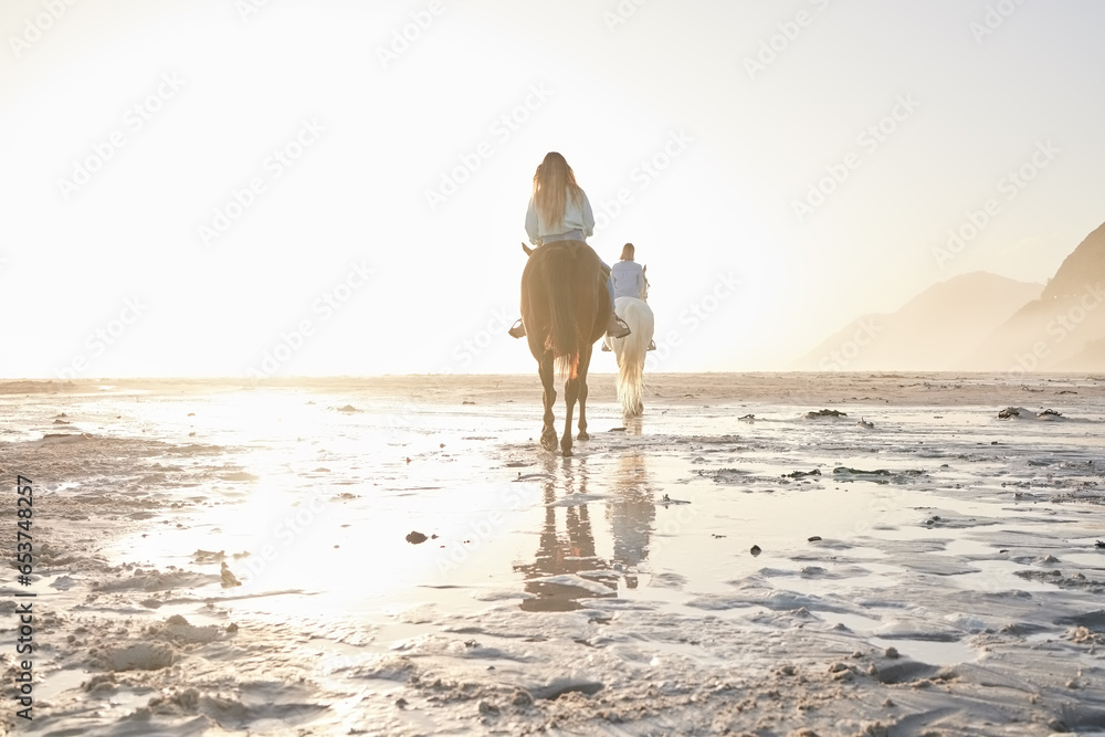 Woman, horse riding and friends on beach with sand for travel, vacation or holiday trip outdoor in nature. Back, people and animal in summer with lens flare by ocean or sea for sunset and travelling