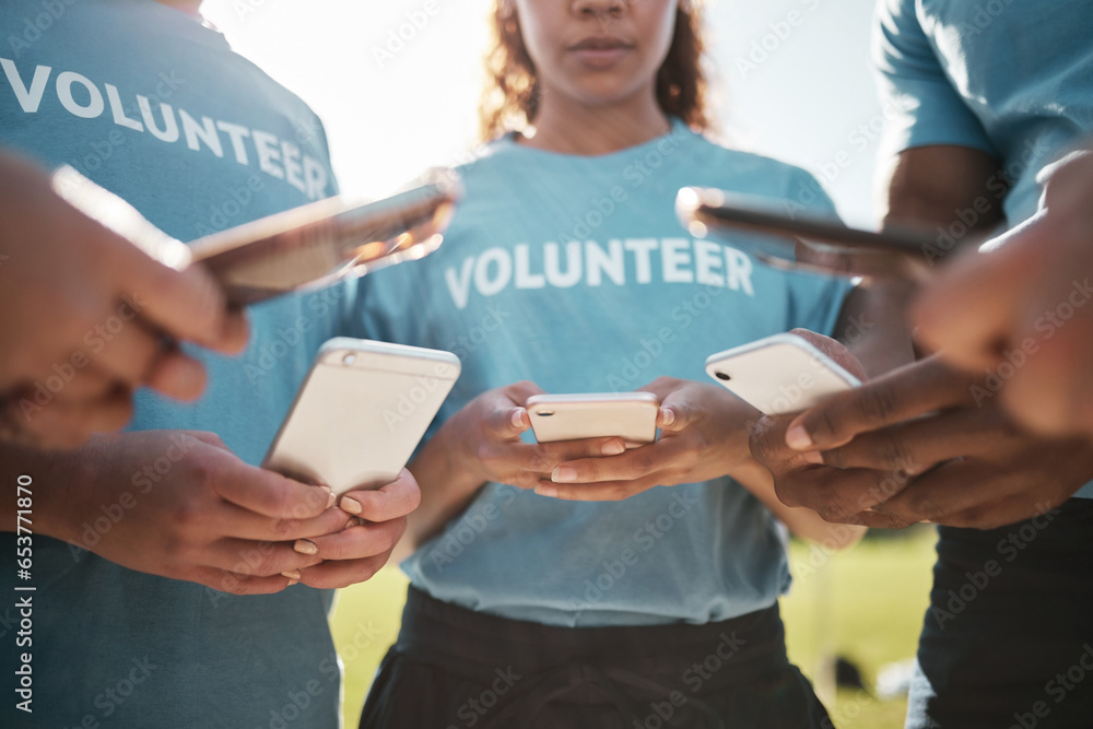 Volunteer, park and hands of people with phone for social media, online chat and charity website. Community service, teamwork and men and women typing on smartphone outdoor for recycle cleaning blog