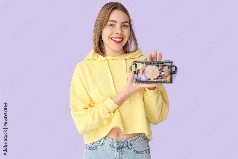 Young woman with transparent cosmetic bag on lilac background