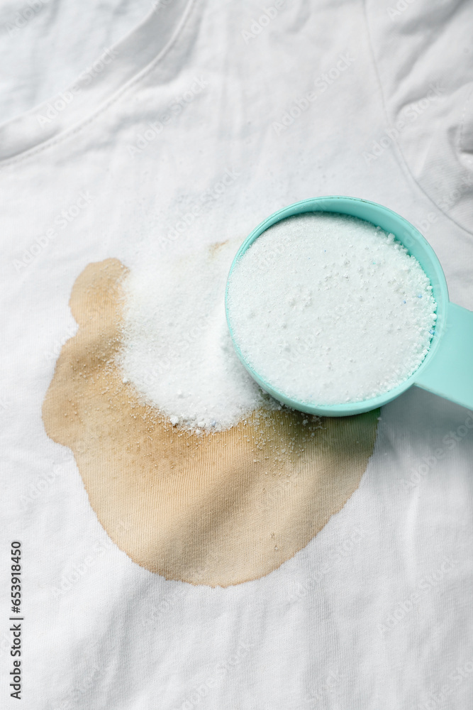 Laundry detergent on stained t-shirt, closeup