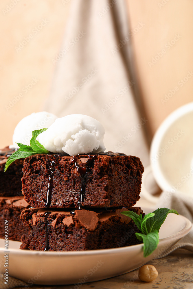 Plate with pieces of tasty chocolate brownie and ice cream on table, closeup