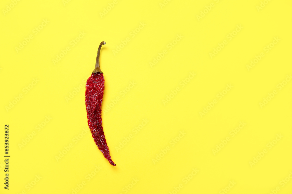 Dry hot chili pepper on yellow background